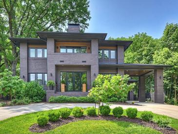 Stunning two-story brick home with manicured landscaping and covered parking at 112 Manning Dr, Charlotte, NC 28209