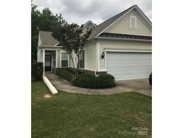 Charming single-story home featuring a two-car garage, manicured lawn, and inviting front porch at 19157 Mallard Dr, Fort Mill, SC 29707
