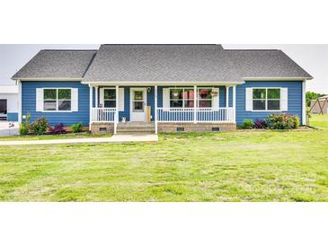 Charming single-story home featuring blue siding, a welcoming front porch, and a well-manicured lawn at 2268 Westbrook Rd, Edgemoor, SC 29712