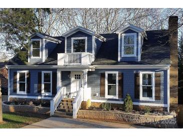 Charming home featuring beautiful blue siding, dormer windows, and a welcoming front porch at 3453 Selwyn Ave, Charlotte, NC 28209