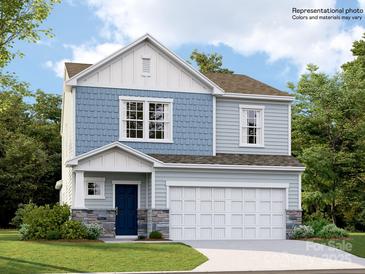 Charming two-story home features a combination of blue siding and stone accents for added curb appeal at 4415 Dusty Orchard Rd, Kannapolis, NC 28081