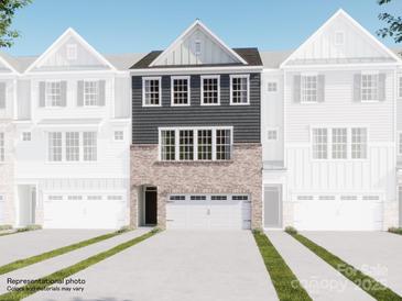 New townhome showcasing a brick and gray facade, attached two car garage, and modern architectural details at 1041 Bandon Dr, Waxhaw, NC 28173