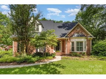 Charming single-Gathering home with brick facade, lush landscaping, and inviting front entrance in a well-maintained yard at 1750 Trellis Dr, Rock Hill, SC 29732