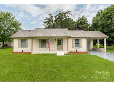 Charming single-story home with a manicured lawn, painted brick, and a covered front porch at 2040 Stratford Dr, Conover, NC 28613