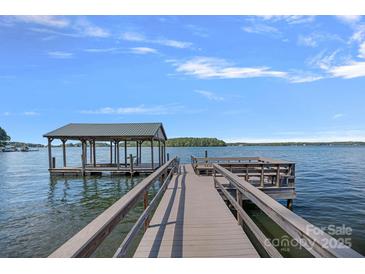 Lake house with a private dock and covered boat slip for easy access to water activities at 392 Stonemarker Rd, Mooresville, NC 28117