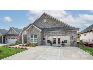 Charming single-story home with a well-manicured lawn and inviting entrance in a desirable neighborhood at 411 Newstyle Way, Gastonia, NC 28056