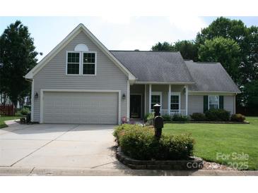 Charming home featuring an attached garage, covered front porch, and well maintained landscaping at 4711 Lenox Hill Pl # 98, Charlotte, NC 28269
