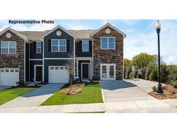 Charming townhome with stone accents, attached garage, and well-maintained landscaping at 545 Trading Post Ln, York, SC 29745
