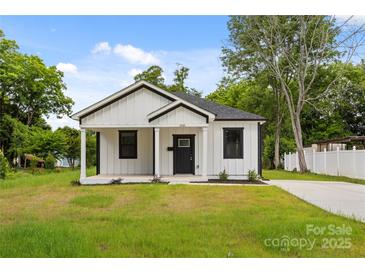 Charming single-story home featuring white siding, a covered porch, and a well-manicured lawn at 1016 Confederate S Ave, Rock Hill, SC 29732