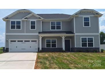 Charming two-story home featuring a two-car garage and a welcoming front porch, offering a blend of comfort and modern design at 118 Kerr Walk Dr # 17, Statesville, NC 28677