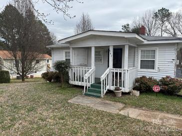 Exterior shot of home's front with porch and landscaping at 341 Talley St, Troutman, NC 28166