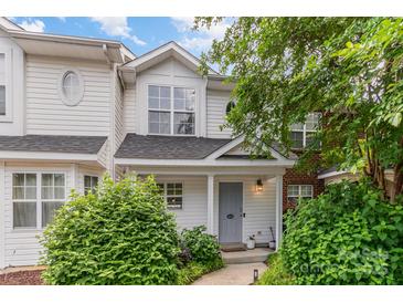 Charming townhouse featuring a well-maintained yard with mature landscaping and a welcoming front porch at 4124 Melrose Club Dr, Matthews, NC 28105