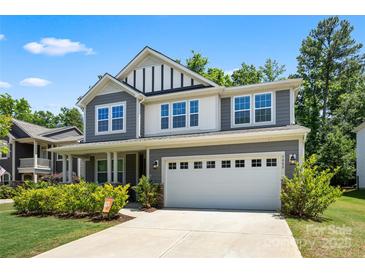 Beautiful two-story home featuring a gray exterior, a two-car garage, and a well-manicured front lawn at 5088 Watersail Way, Clover, SC 29710