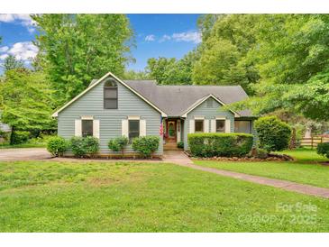 Charming single-story home with lush front yard, well maintained landscaping, and sidewalk at 8506 Graham Rd, Denver, NC 28037