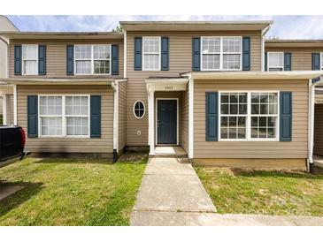 Charming townhome featuring a well-maintained front yard, tan siding, and dark blue shutters at 5343 Esther Ln, Charlotte, NC 28214
