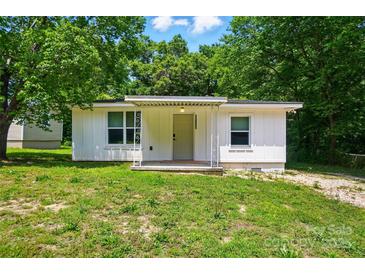 Charming home featuring a covered front porch, white siding, and well-maintained landscaping at 13821 David St, Huntersville, NC 28078