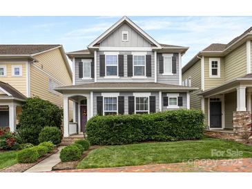 Charming two-story home with a well-manicured lawn and inviting front porch at 2313 Blueberry St, Belmont, NC 28012