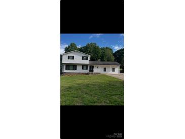 Charming two-story home with landscaped yard and white siding at 2412 Elizabeth Ave, Staley, NC 28150