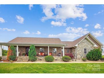 Charming brick home with stone accents, covered front porch and beautifully landscaped front yard at 2843 Startown Rd, Lincolnton, NC 28092