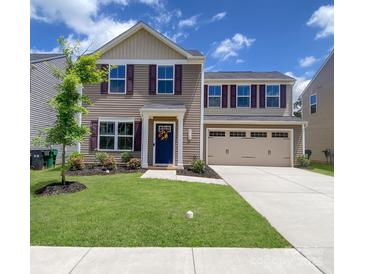 Charming two-story home with a well-manicured lawn, colorful landscaping, and a two-car garage at 3113 Bouquet St, Charlotte, NC 28215