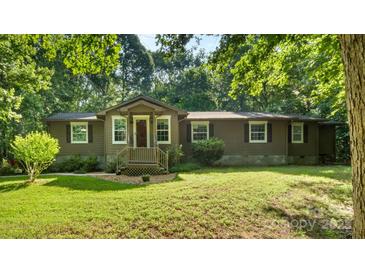 Charming home with inviting entrance, well-maintained lawn, and mature trees providing a peaceful setting at 8321 Walkup Rd, Waxhaw, NC 28173