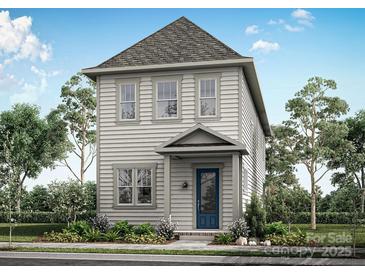 Charming two-story home with a blue front door and beautifully landscaped front yard and gray siding at 9109 Maybry Park St # Lot 115, Charlotte, NC 28212
