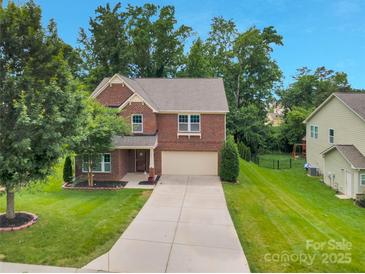 Charming two-story brick home with a well-manicured lawn and an inviting driveway at 1017 Quail Run Ct, Indian Land, SC 29707