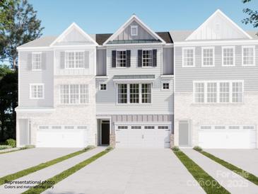 Charming townhome featuring a two-car garage, complemented by decorative shutters and stylish architectural details at 1029 Bandon Dr, Waxhaw, NC 28173