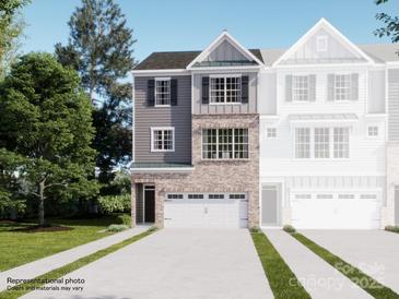 New two-story townhouse with brick and gray siding, attached garage, and manicured lawn at 1033 Bandon Dr, Waxhaw, NC 28173