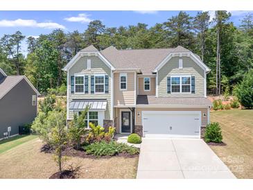 Charming two-story home featuring a two-car garage, landscaped yard, and inviting curb appeal at 14611 Murfield Ct, Charlotte, NC 28278