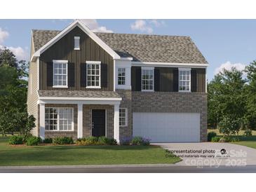 Charming two-story home with a brick and dark siding exterior and an attached two-car garage at 1511 River Cane St, Edgemoor, SC 29712