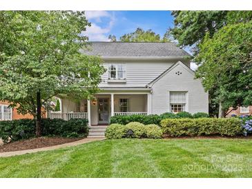 Charming two-story home with manicured lawn and lush landscaping creating inviting curb appeal at 2814 Glendale Rd, Charlotte, NC 28209