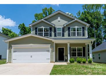 Charming two-story home with sage siding, black shutters, a covered front porch, and a two-car garage at 3403 Keith Dr, Charlotte, NC 28269