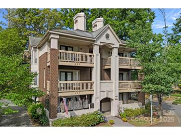 Stunning condo building with brick and painted accents, multiple decks, manicured landscaping, and a welcoming entrance at 409 W 8Th St, Charlotte, NC 28202
