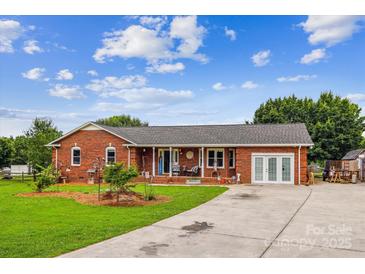 Charming brick ranch-style home with a welcoming front porch and well-manicured lawn at 4527 Marshall Ct, Monroe, NC 28110