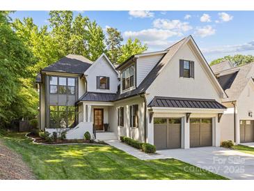 Stunning two-story home featuring a brick facade, attached garage, and professionally landscaped front yard at 6013 Camile Ct, Charlotte, NC 28226