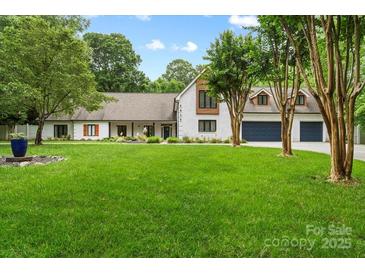 Charming brick home with a well-manicured lawn and mature trees, offering great curb appeal at 7017 S Providence Rd, Waxhaw, NC 28173