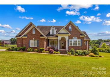 Charming, two-story brick home featuring a well-manicured lawn and inviting front porch at 1070 Blueberry Rd, Salisbury, NC 28147