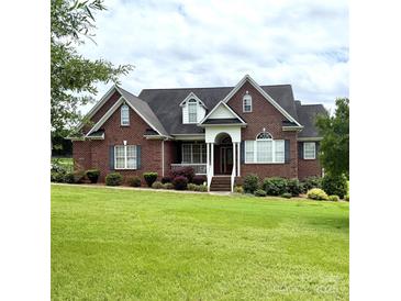 Charming brick home featuring a well-manicured lawn and welcoming front porch at 1070 Blueberry Rd, Salisbury, NC 28147