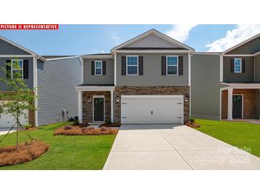 Charming two-story home with stone accents, attached garage and landscaped front yard at 11213 Cardinal Creek Ave, Charlotte, NC 28215