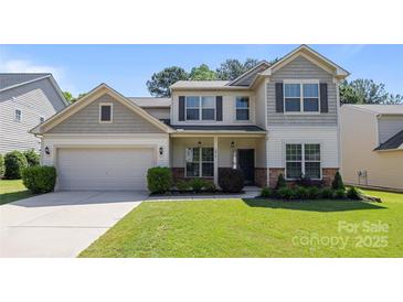 Charming two-story home with a well-manicured lawn, neutral siding, and an attached two-car garage at 1814 Still Water Ln, Fort Mill, SC 29707