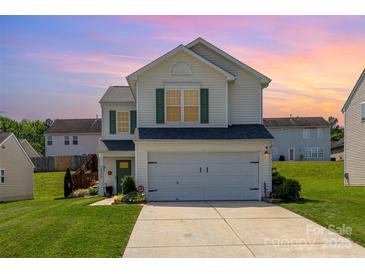 Charming two-story home with a well-maintained lawn, green shutters, and a two-car garage at 2636 Forest Grove Ct, Charlotte, NC 28269