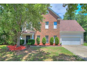 Charming two-story brick home with a well-maintained front yard and mature landscaping at 6310 Trevor Simpson Dr, Indian Trail, NC 28079