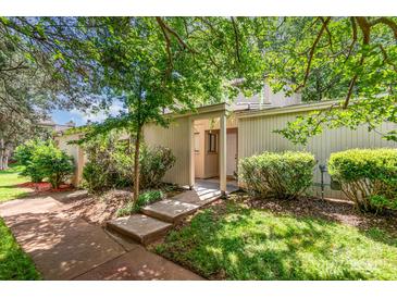 Charming home exterior with lush landscaping and inviting walkway at 8005 Horse Chestnut Ln, Charlotte, NC 28277