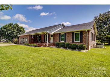 Charming brick ranch-style home with a well-manicured lawn and inviting front porch at 801 Witmore Rd, Wingate, NC 28174
