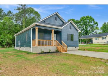 Charming blue home with a wooden porch and a well-maintained front yard at 105 Churchill Dr, Kings Mountain, NC 28086