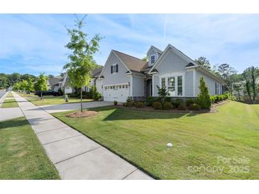 Charming single-story home with manicured lawn, stone accents, and two-car garage at 14531 Crosswater Ln, Charlotte, NC 28278