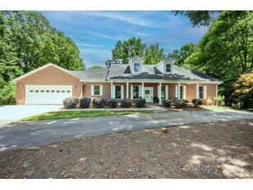 Charming one-story brick home with white trim, dormer windows, and a well-manicured front yard at 169 Wilcox Karriker Ln, Statesville, NC 28625