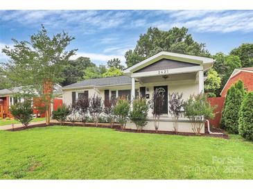Charming single-story home featuring a covered porch and well-manicured front lawn at 2421 Shamrock Dr, Charlotte, NC 28205