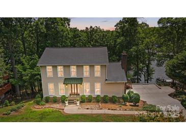 Charming two-story traditional home featuring a landscaped front yard and covered front porch at 29049 Snapper Pt, Tega Cay, SC 29708